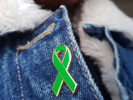 Green ribbon on a coat