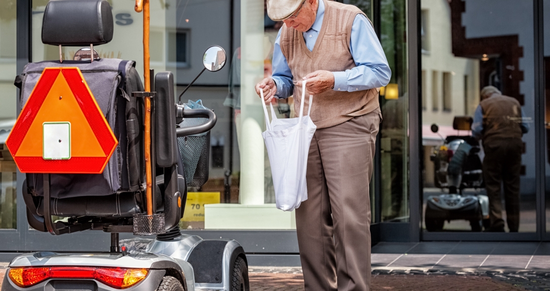 Man standing next to mobility scooter