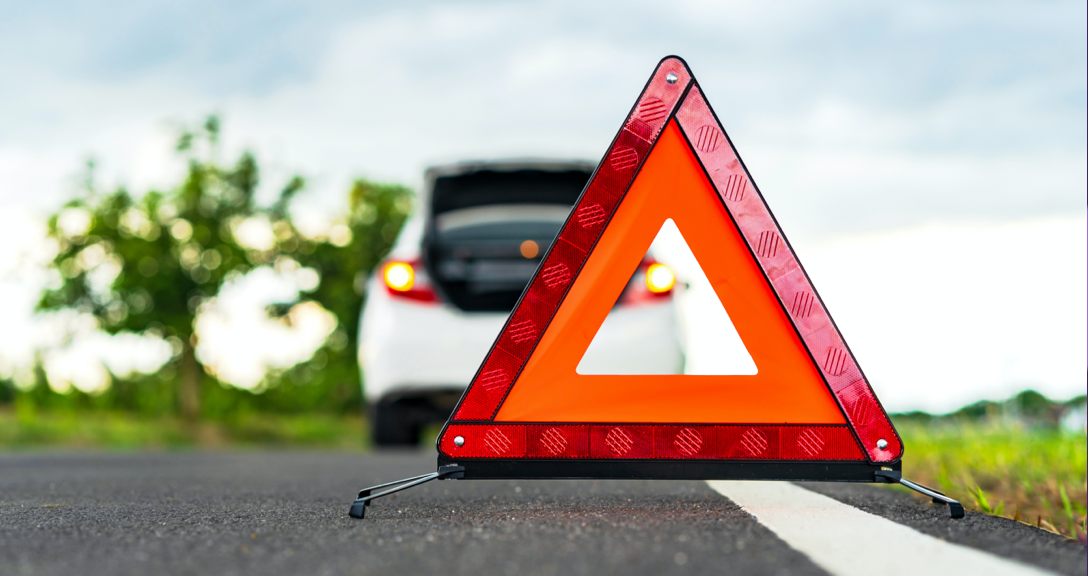 Warning triangle by a car